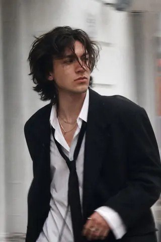 Young Man in Urban Fashion Editorial Pose - AI copy paste AI prompt example for aesthetic, fashion